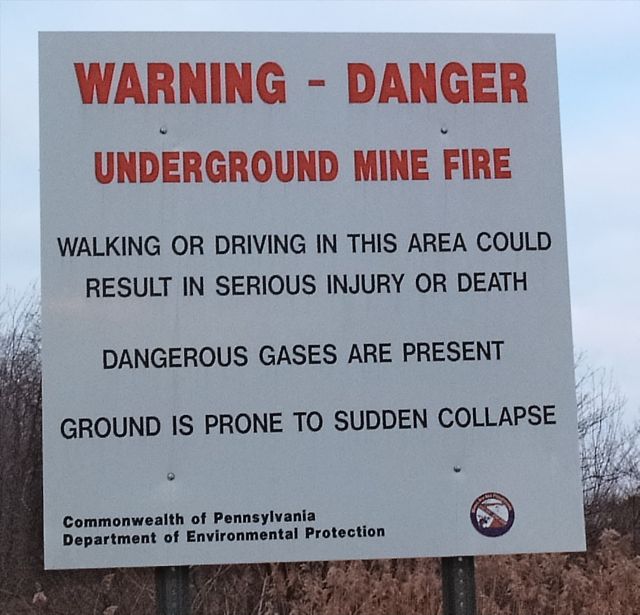 The Pennsylvania DEP warning sign at the start of Route 61 in Centralia: underground mine fire, dangerous gases, ground prone to sudden collapse.